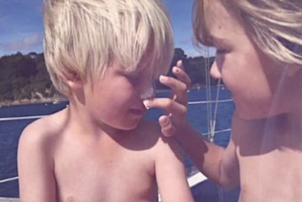 Children applying Shade All-Natural Sunscreen to each other
